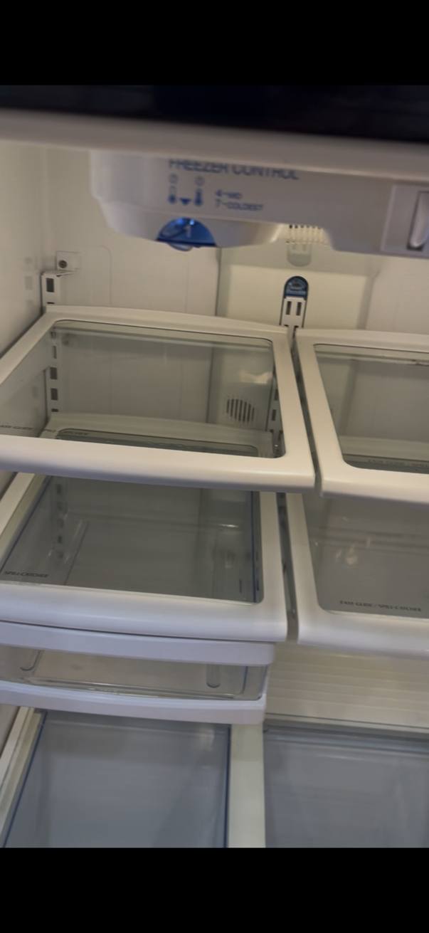 The same refrigerator after cleaning, with clear shelves and drawers