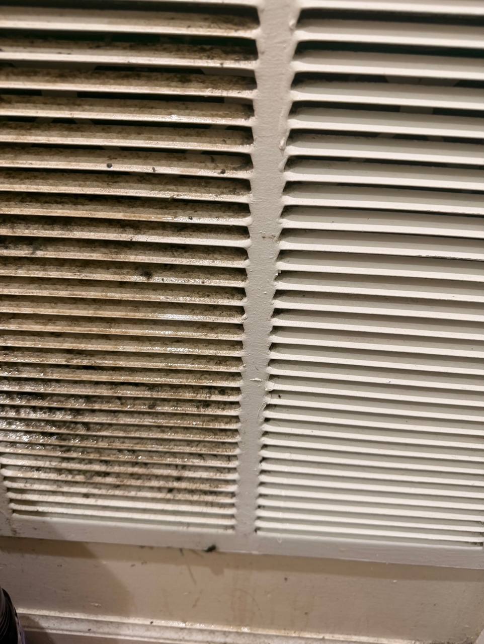 Air vent shown half cleaned and half covered in dust buildup