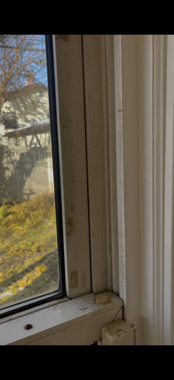 Window frame and sill before cleaning, showing scuffs and buildup